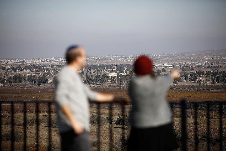 People look towards an area in the distance