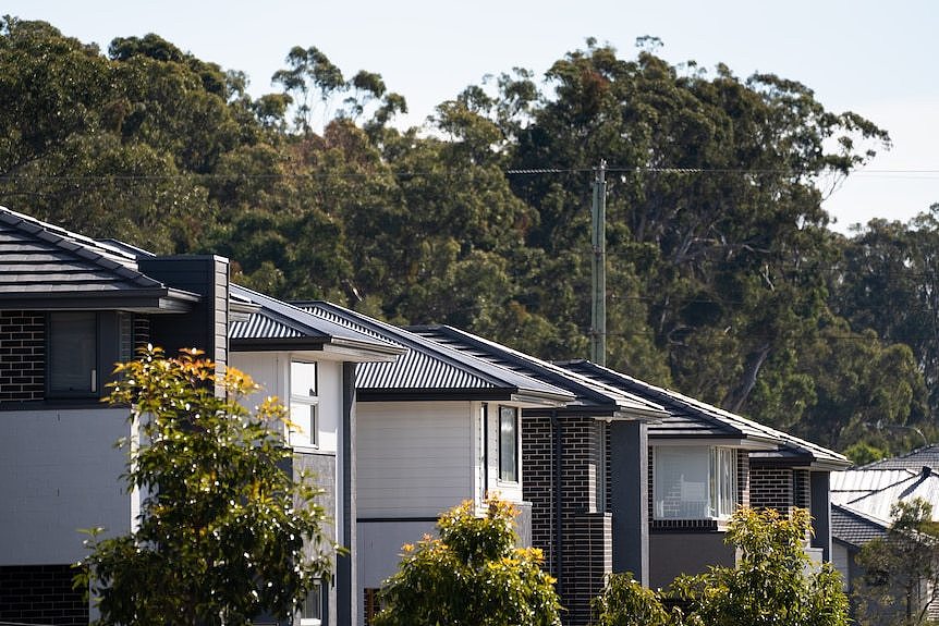 Houses under construction on a bright, sunny day