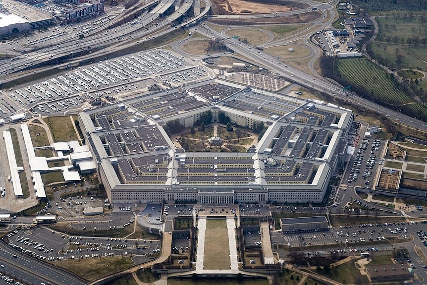 An aerial shot of the Pentagon — a large, five-sided office building with carparks