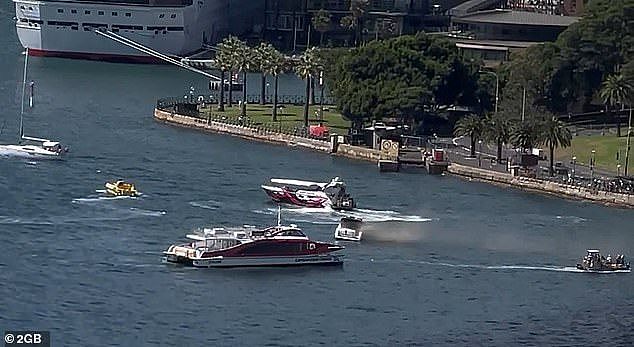 Emergency services has rushed to the aid of nine boat passengers after the vessel burst into flames underneath the Sydney Harbour Bridge on Monday (pictured)