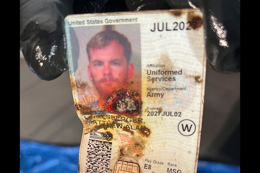 A burnt ID document featuring the photo of Matthew Livelsberger