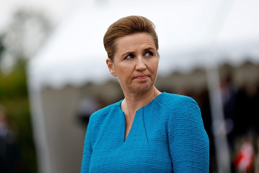 Denmark's Prime Minister Mette Frederiksen in a blue dress.