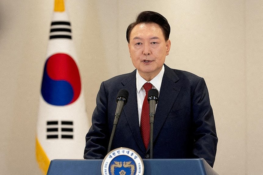 South Korean President Yoon Suk Yeol delivers an address to the nation from behind a lectern at the Presidential Office.