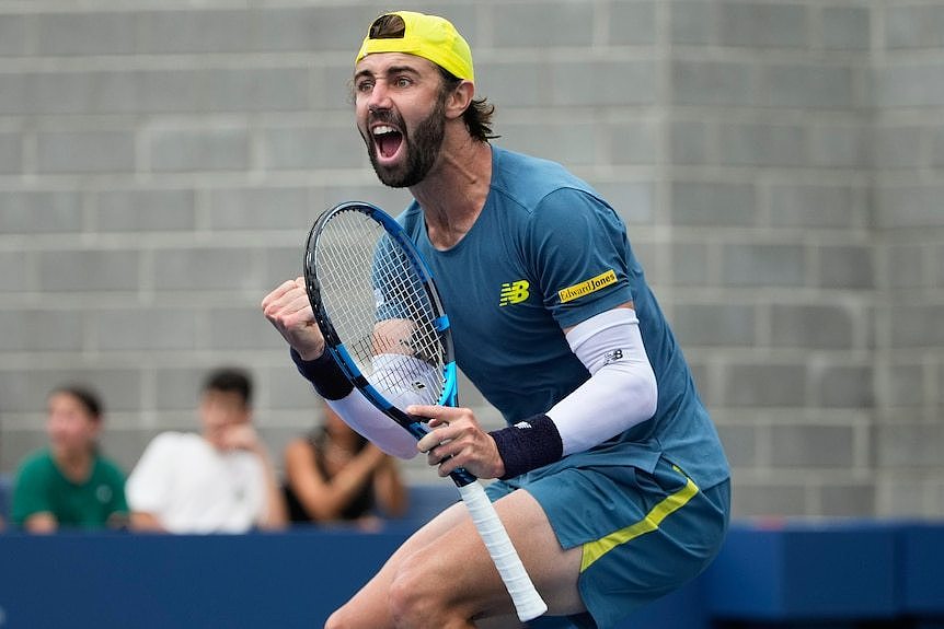 Jordan Thompson pumps his fist after winning a point