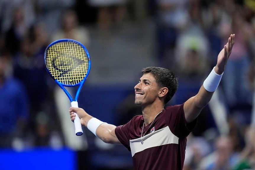 Alexei Popyrin holds up his hands