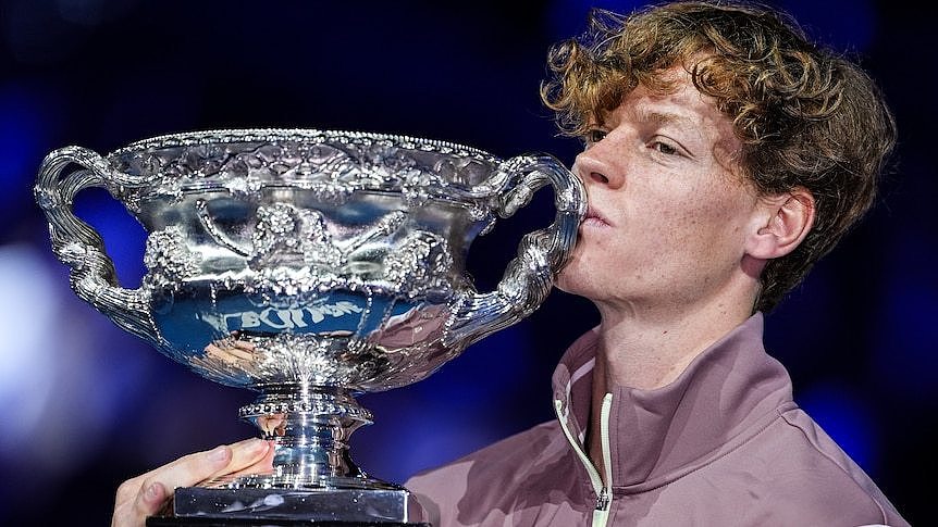 Jannik Sinner kisses the Norman Brookes Challenge Cup.