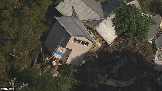 An entire house has fallen down a cliff (pictured) on a residential street after a deafening landslide rocked Melbourne's Mornington Peninsula on Tuesday