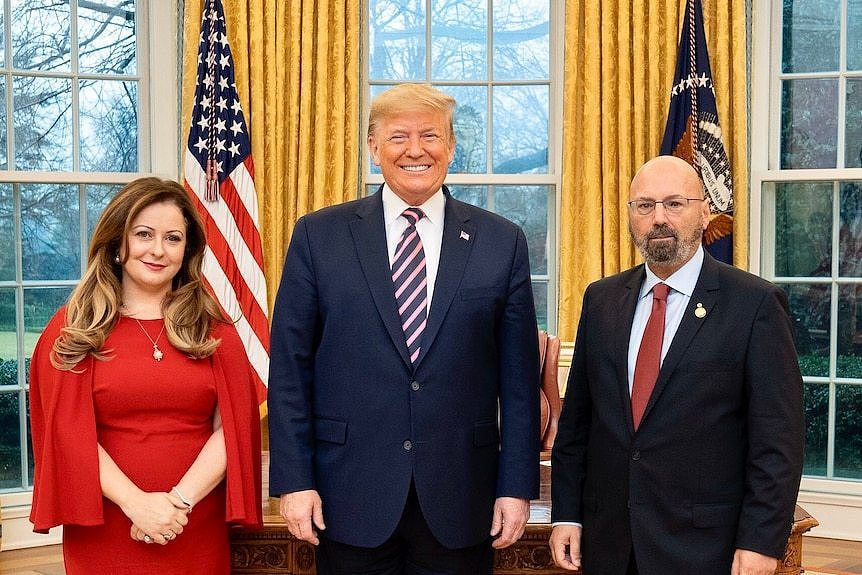 Donald Trump standing in the Oval Office. To his left is Arthur Sinodinos and to his right, Arthur's wife Elizabeth.