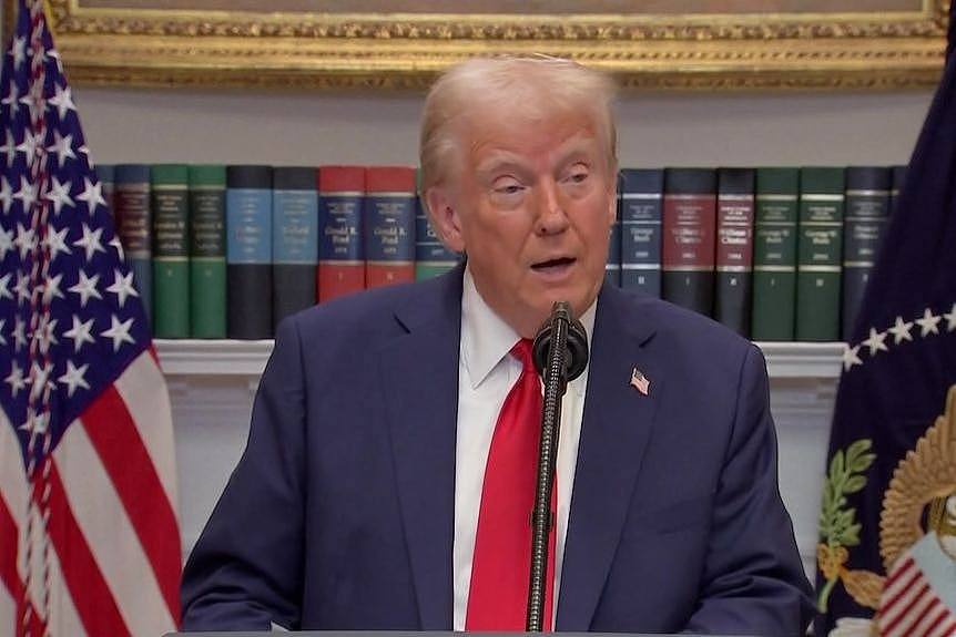 donald trump in red tie speaking at a press conference