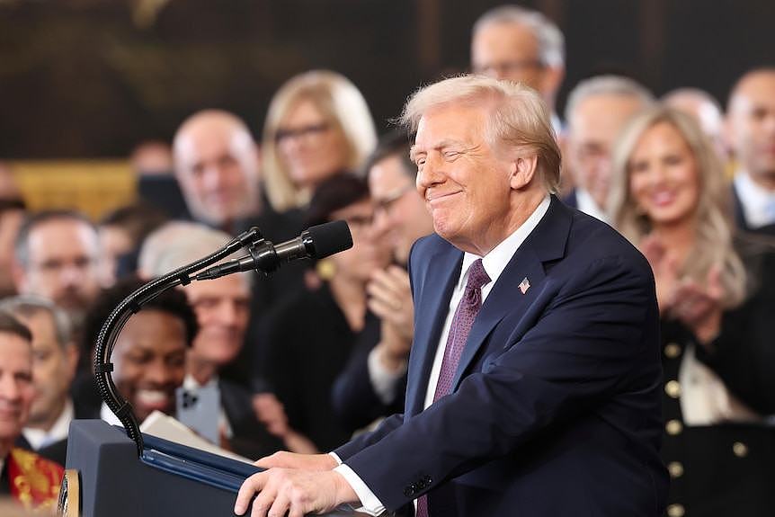 Donald Trump speaks at a podium during his second inauguration.