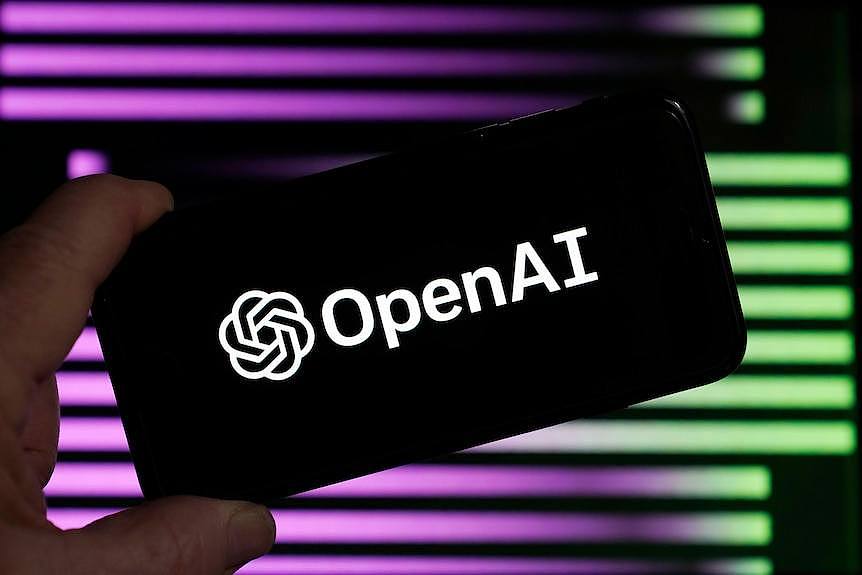 A smartphone says Open AI in front of a purple and green background. 