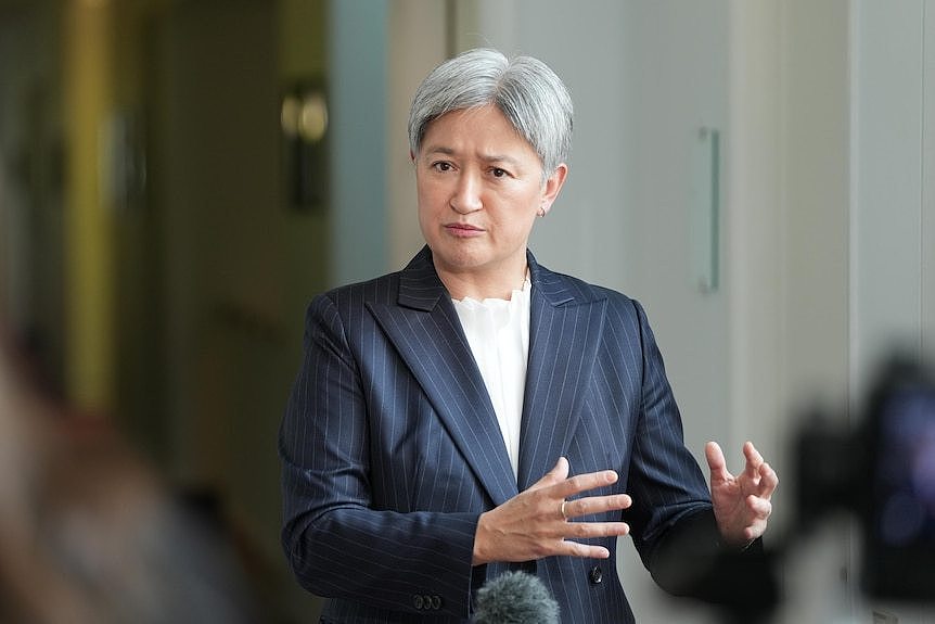 Penny Wong holds a press conference in a corridor in Parliament House