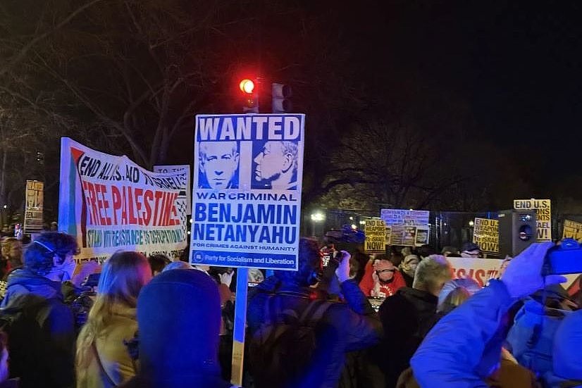 Protestors hold blacards outside the White House during Israeli PM Benjamin Netanyahu's visit.