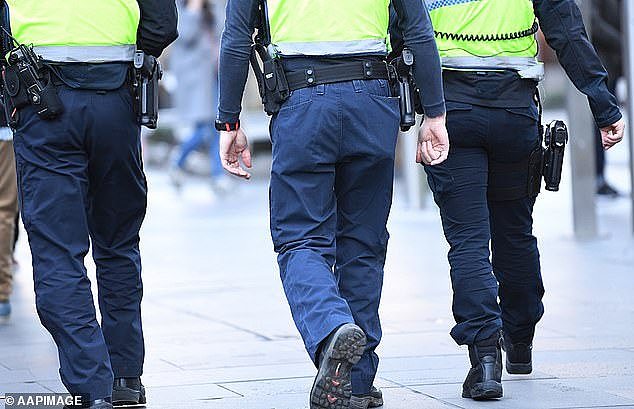 It remains unclear how many alleged offenders who used a BailSafe ankle monitor are currently in Victoria (pictured, police officers in Melbourne)