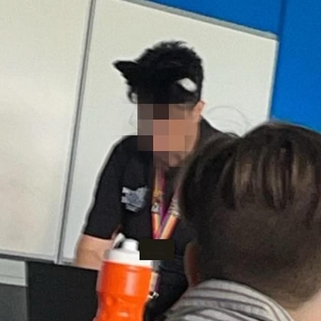 A high school teacher who allegedly identifies as a cat has been accused of 'hissing' at students and licking the back of their hands in class (pictured)