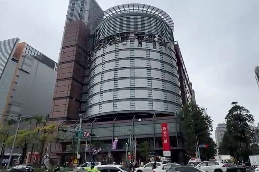 the damaged facade of the Shin Kong Mitsukoshi department store after an explosion