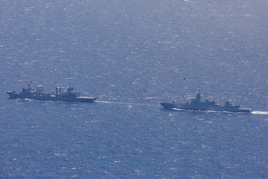 Two warships in the ocean. 