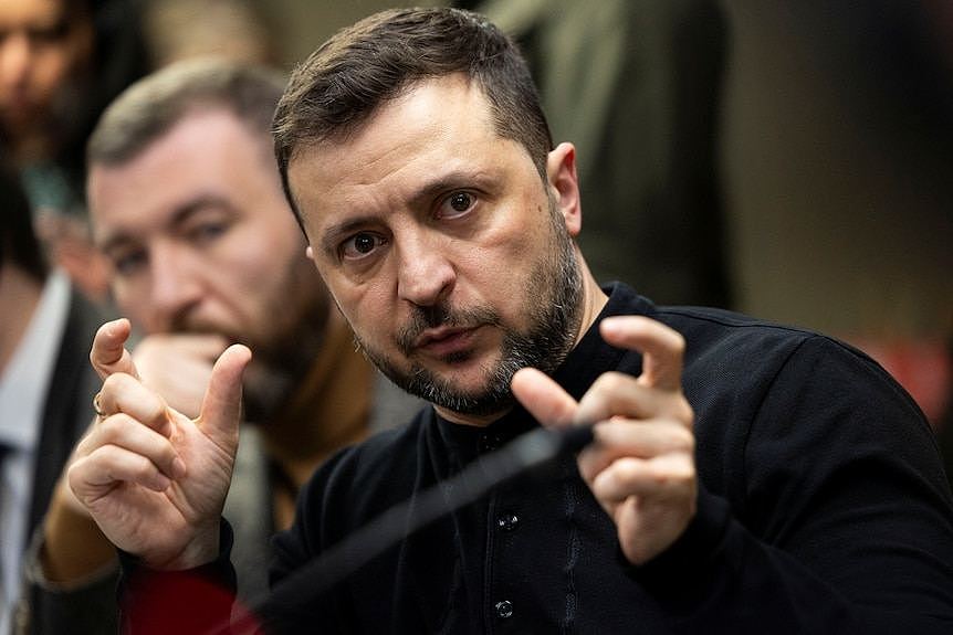 Volodymyr Zelenskyy gestures as he talks to media 