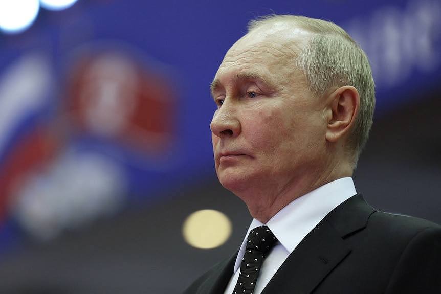 A sad-looking Putin, viewed from the side.