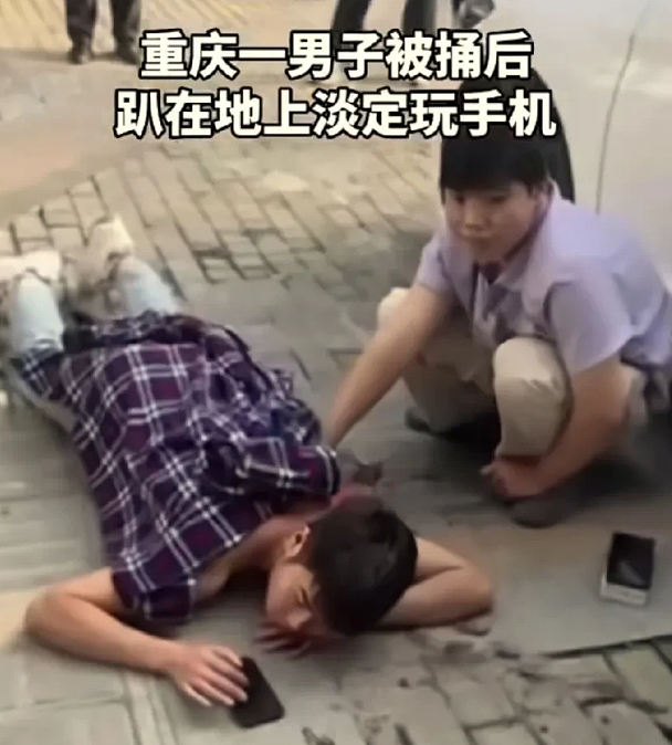 手机是“疗伤神器”？男子被捅后趴在地上淡定玩手机（视频/组图） - 1