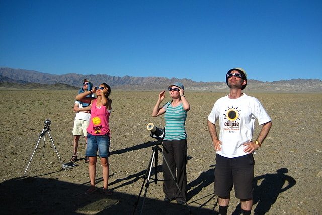 Group of people looking at a solar eclipse with glasses