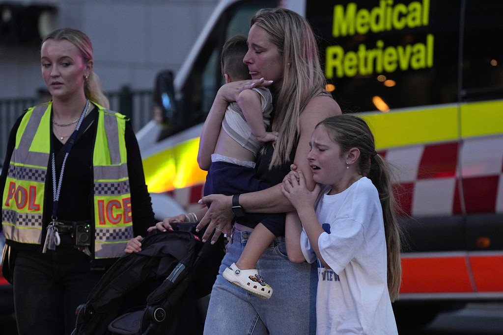 澳洲最大城悉尼13日下午有歹徒持刀枪闯入一处购物中心攻击，随着家人疏散的女孩吓哭。 （美联社）